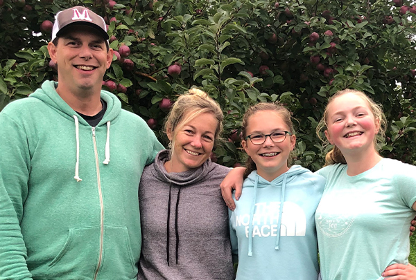 Trevor’s wife, Sarah, and their teenage daughters join him for one of their favorite family outings, picking apples.